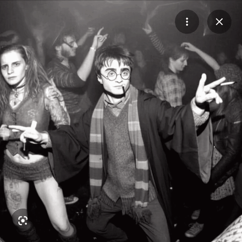 a black and white photo of a man dressed as harry potter giving the peace sign