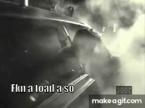 a black and white photo of a man driving a car with smoke coming out of it .