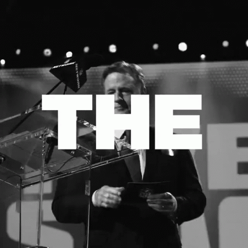 A Black And White Photo Of A Man Giving A Speech With The Word The Above Him GIF