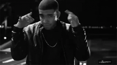 A Black And White Photo Of A Man Giving The Middle Finger While Standing In Front Of A Car . GIF