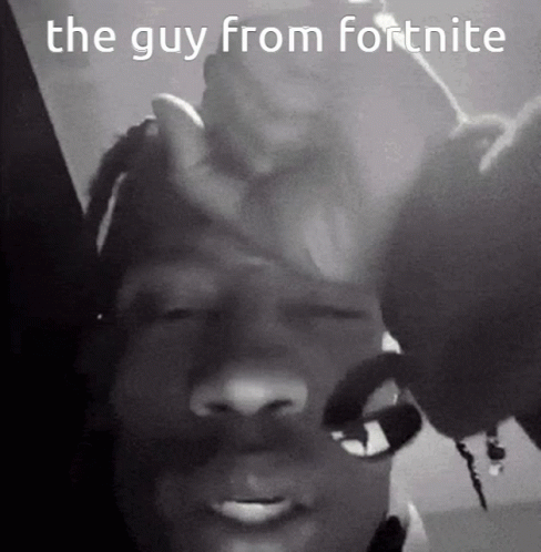 A Black And White Photo Of A Man Holding His Hand To His Forehead . GIF