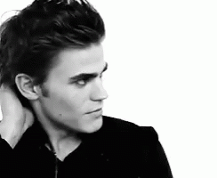 A Black And White Photo Of A Man Holding His Neck GIF