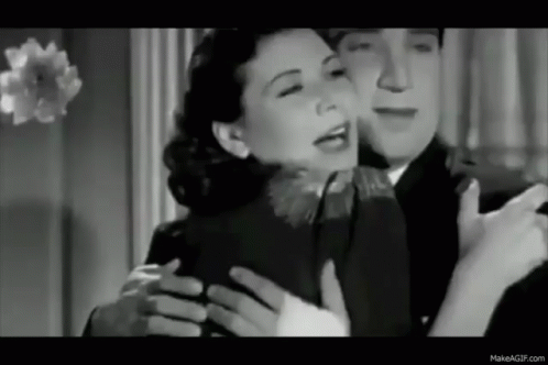 A Black And White Photo Of A Man Hugging A Woman . GIF