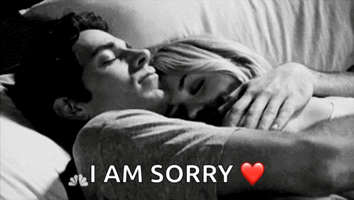 A Black And White Photo Of A Man Hugging A Woman With The Words I Am Sorry Above Them GIF