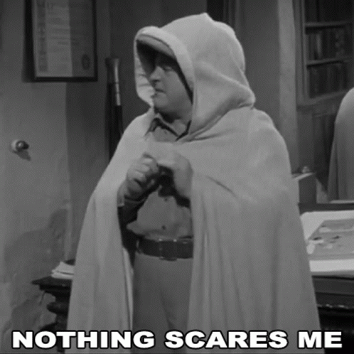 A Black And White Photo Of A Man In A Cape With The Caption " Nothing Scares Me " GIF