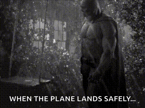 A Black And White Photo Of A Man In A Cape With The Caption " When The Plane Lands Safely ... " GIF