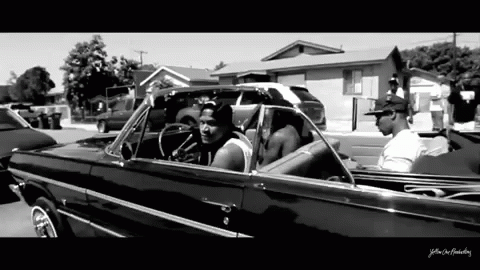 A Black And White Photo Of A Man In A Car With The Words Yellow On The Bottom Right GIF