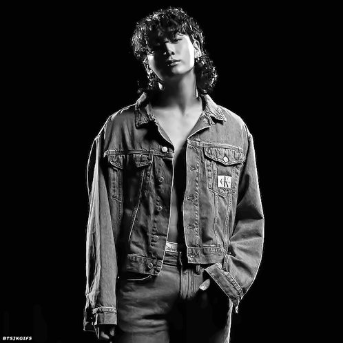 A Black And White Photo Of A Man In A Denim Jacket GIF