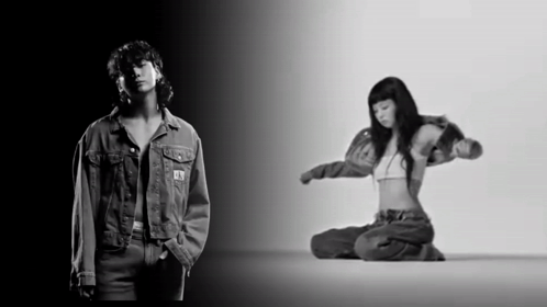 A Black And White Photo Of A Man In A Denim Jacket And A Woman In A Bra GIF