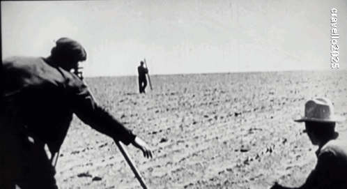 A Black And White Photo Of A Man In A Field With The Year 2005 On The Bottom Right GIF