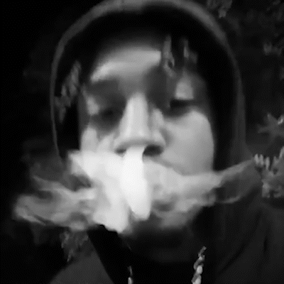 A Black And White Photo Of A Man In A Hoodie Smoking A Cigarette . GIF