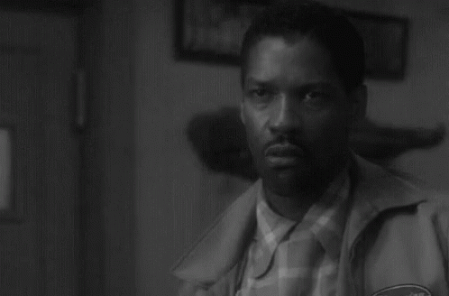A Black And White Photo Of A Man In A Jacket GIF