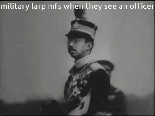 A Black And White Photo Of A Man In A Military Uniform GIF