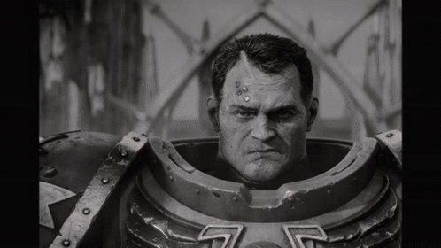 A Black And White Photo Of A Man In A Robot Costume Looking At The Camera . GIF