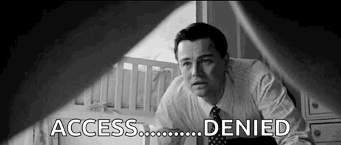 A Black And White Photo Of A Man In A Suit And Tie Looking At A Baby Crib . GIF