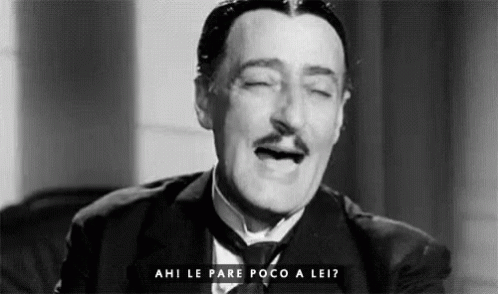 A Black And White Photo Of A Man In A Suit And Tie With His Eyes Closed And The Words Ahi Le Pare Poco A Lei GIF