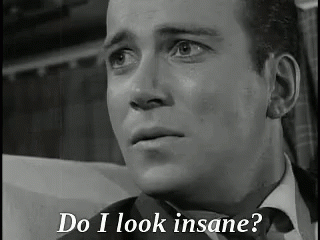 A Black And White Photo Of A Man In A Suit And Tie With The Words `` Do I Look Insane '' Written Below Him . GIF