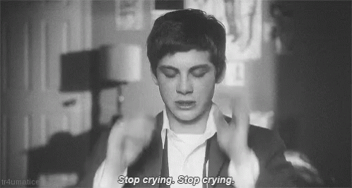 A Black And White Photo Of A Man In A Suit With The Words `` Stop Crying , Stop Crying '' Written On It . GIF