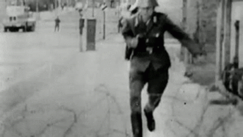 Black And White Photo Of Man Running In Uniform GIF