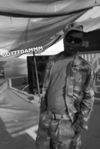 A Black And White Photo Of A Man In A Us Army Uniform GIF
