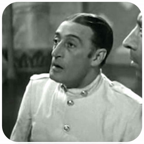 A Black And White Photo Of A Man In A White Jacket GIF