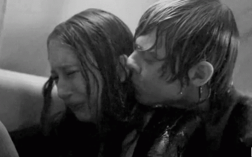 A Black And White Photo Of A Man Kissing A Woman In A Bathtub . GIF