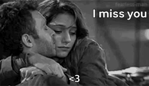 A Black And White Photo Of A Man Kissing A Woman On The Forehead . GIF