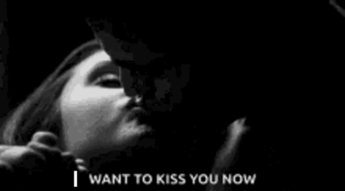 A Black And White Photo Of A Man Kissing A Woman . GIF
