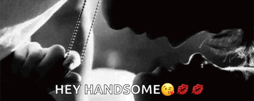 A Black And White Photo Of A Man Kissing A Woman With The Words Hey Handsome Below Them GIF