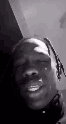 A Black And White Photo Of A Man Making A Funny Face . GIF