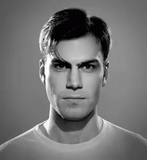 A Black And White Photo Of A Man Making A Funny Face GIF