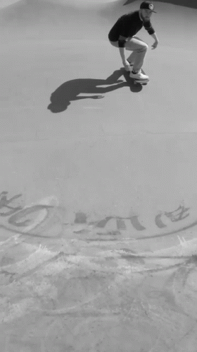 A Black And White Photo Of A Man On A Skateboard With A Drawing Of A Key And A Skateboard On The Ground GIF