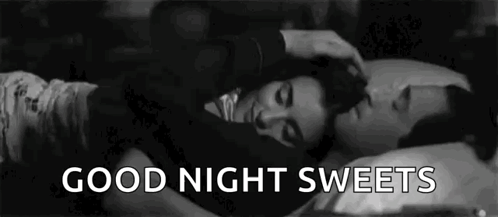 A Black And White Photo Of A Man Petting A Woman 'S Head While They Sleep . GIF