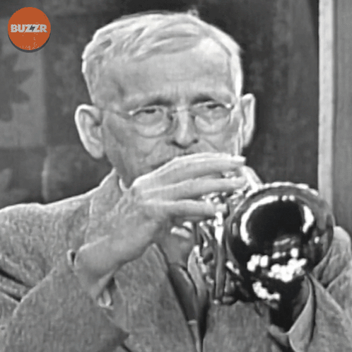 A Black And White Photo Of A Man Playing A Trumpet With A Buzzr Logo Above Him GIF