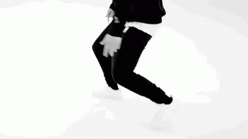 A Black And White Photo Of A Man Pointing At His Chest . GIF