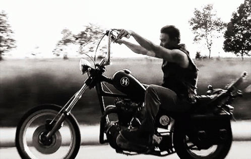 Black And White Photo Of Man Riding Chopper GIF