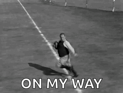 A Black And White Photo Of A Man Running With A Football With The Words On My Way Below Him GIF