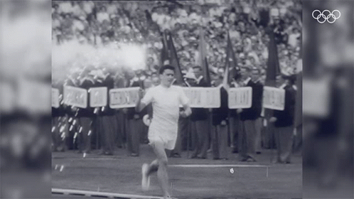 a black and white photo of a man running with a sign that says ' freedom ' on it