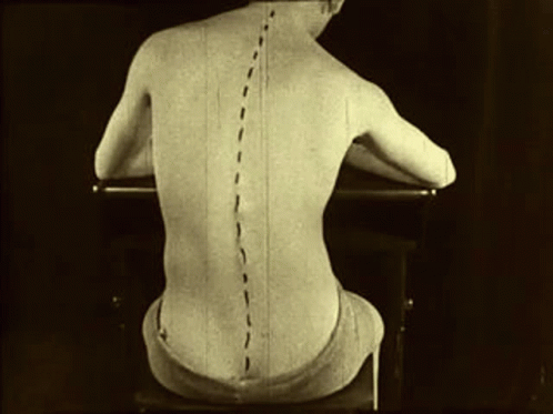 A Black And White Photo Of A Man 'S Back With Lines Drawn On It GIF