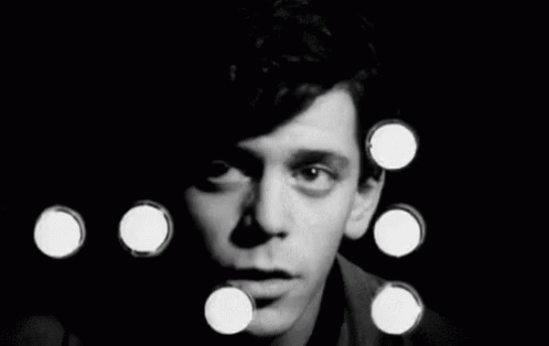 A Black And White Photo Of A Man 'S Face Surrounded By Circles . GIF