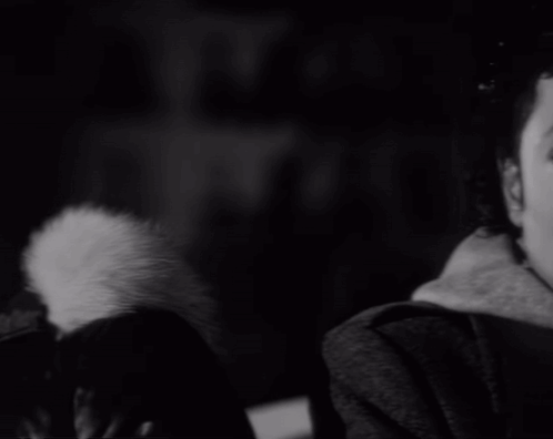 A Black And White Photo Of A Man 'S Face With A Serious Look On His Face GIF