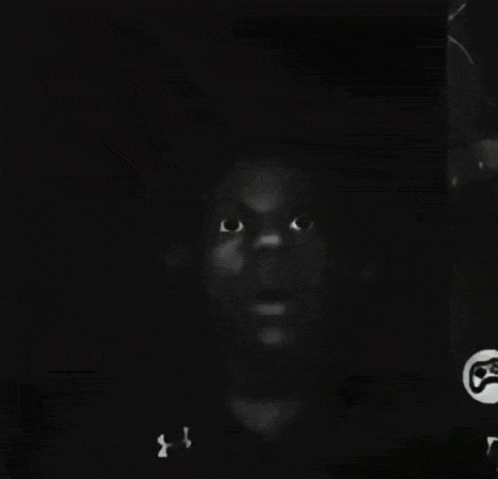 a black and white photo of a man 's face with a under armour shirt on