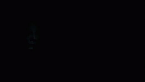 A Black And White Photo Of A Man 'S Face With A White Mask On GIF