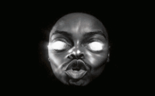 A Black And White Photo Of A Man 'S Face With Glowing Eyes GIF