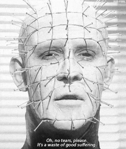 a black and white photo of a man 's face with nails on it .
