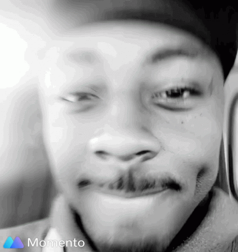 A Black And White Photo Of A Man 'S Face With The Word Momento On The Bottom GIF