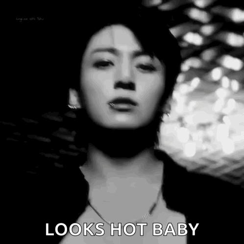 A Black And White Photo Of A Man 'S Face With The Words `` Looks Hot Baby '' Written On It . GIF