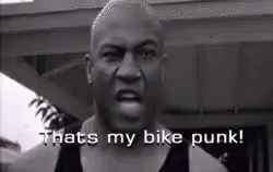 A Black And White Photo Of A Man Saying `` That 'S My Bike Punk '' . GIF