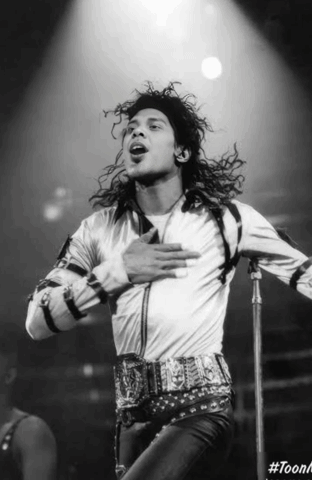 A Black And White Photo Of A Man Singing Into A Microphone With The Hashtag #Toonk GIF