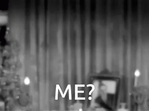A Black And White Photo Of A Man Sitting At A Table With The Words Me Written In White GIF